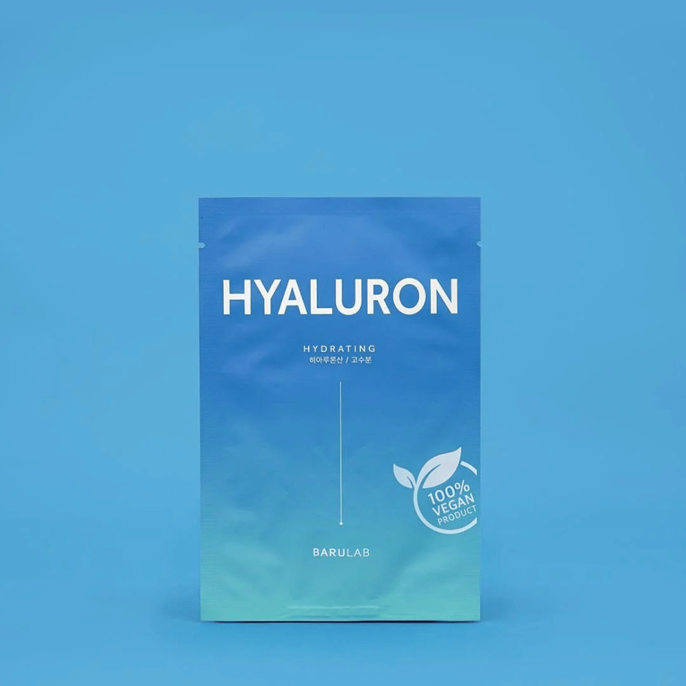 Una confezione di BARULAB maschera "HYALURON Hydrating", contrassegnata come "100% Vegan Product", davanti a uno sfondo blu uniforme. La confezione ha una gradazione di colore dal blu scuro al blu chiaro.