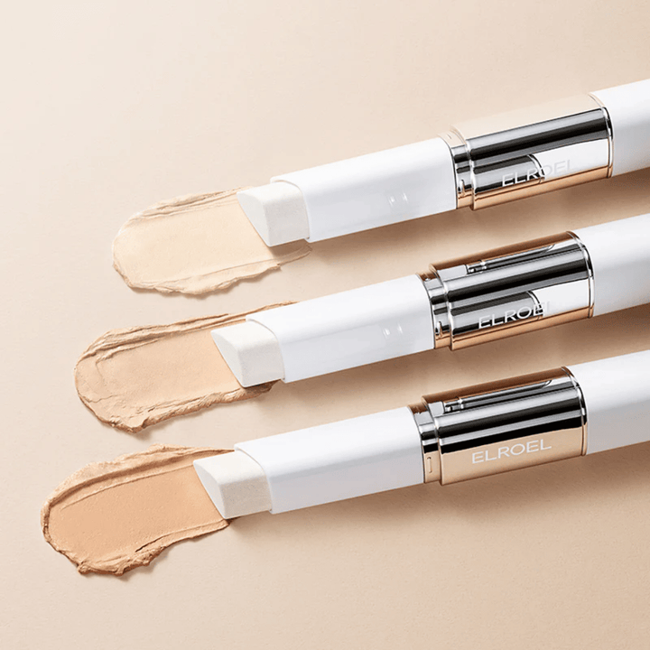 ELROEL Blanc Cover Cream Stick concealer con pennello integrato, diversi stick allineati che mostrano il design del prodotto e l'applicazione.