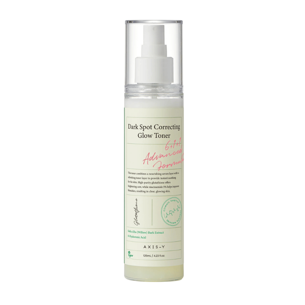 Un'immagine di una bottiglia del prodotto "AXIS-Y Dark Spot Correcting Glow Toner". La bottiglia è trasparente con un'etichetta bianca e testo in nero e verde. Il prodotto è uno tonico viso in forma spray e la bottiglia contiene 125 ml (4,23 fl. oz). L'etichetta menziona ingredienti chiave come l'estratto di corteccia di salice e l'acido ialuronico.