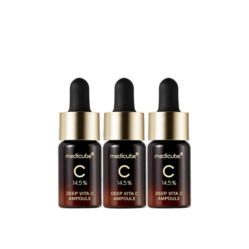 Tre bottiglie di Medicube Deep Vita C Ampoule, con il 14,5% di vitamina C, disposte in fila. Le bottiglie hanno un design elegante con base marrone scuro e tappo dorato. Perfetto per un tono della pelle più luminoso e una texture della pelle più uniforme.
