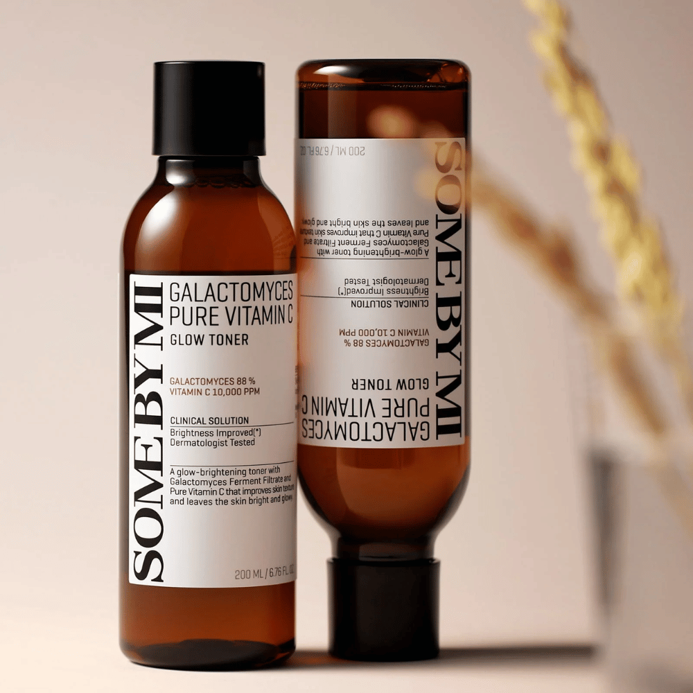 Immagine di SOME BY MI Galactomyces Pure Vitamin C Glow Toner. Le bottiglie hanno un design elegante con tonico viso marroni e tappo nero. Il prodotto contiene l'88% di galactomyces e 10.000 ppm di vitamina C, il che promette di migliorare la luminosità della pelle e donare un incarnato più fresco.