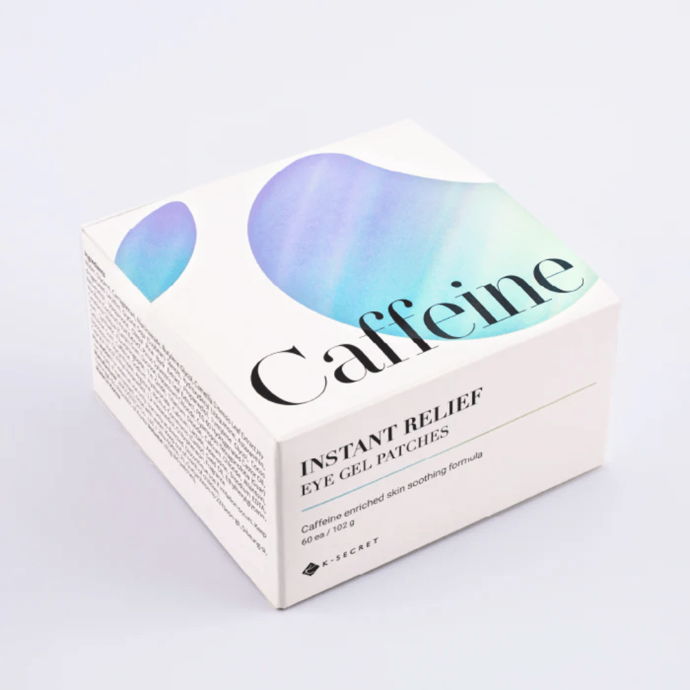 Confezione di K-Secret Instant Relief Eye Gel Patches con caffeina in design bianco con tonico viso blu e verde.