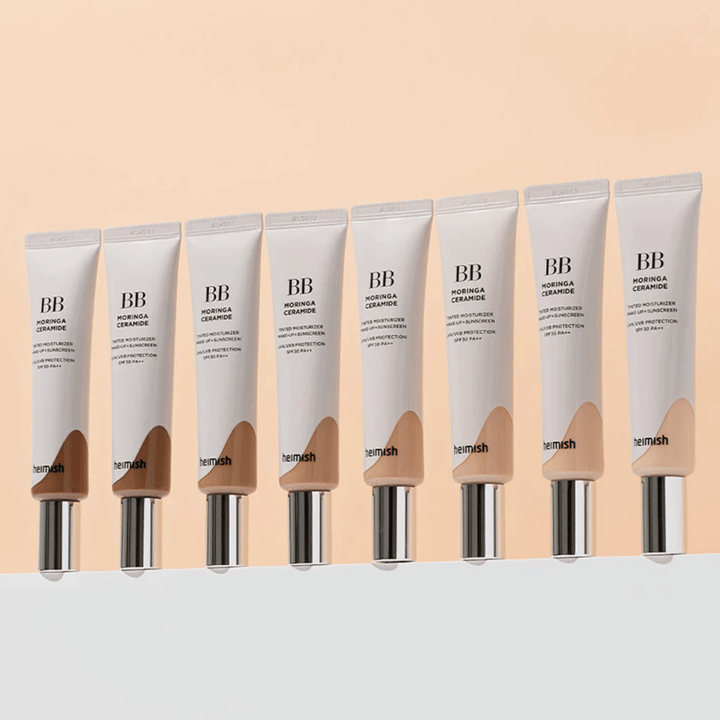 Fila di Heimish Moringa Ceramide BB Cream in diverse tonalità di colore. L'immagine illustra la variazione da tonico viso più chiari a più scuri per adattarsi a diversi incarnati ed esigenze.