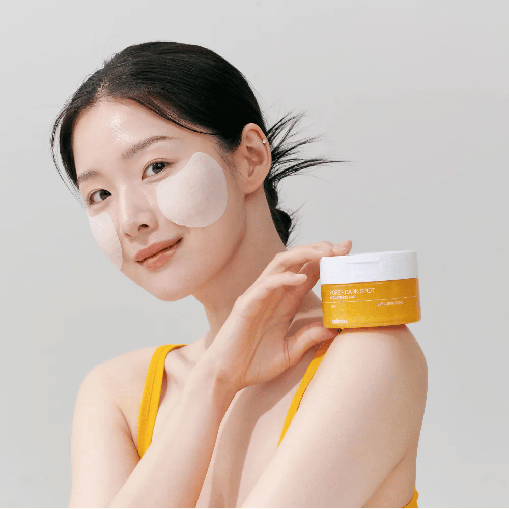 Donna applica Celimax Pore + Dark Spot Brightening Pad – pads coreani che uniformano il tono della pelle e riducono i pori e le macchie di pigmentazione.