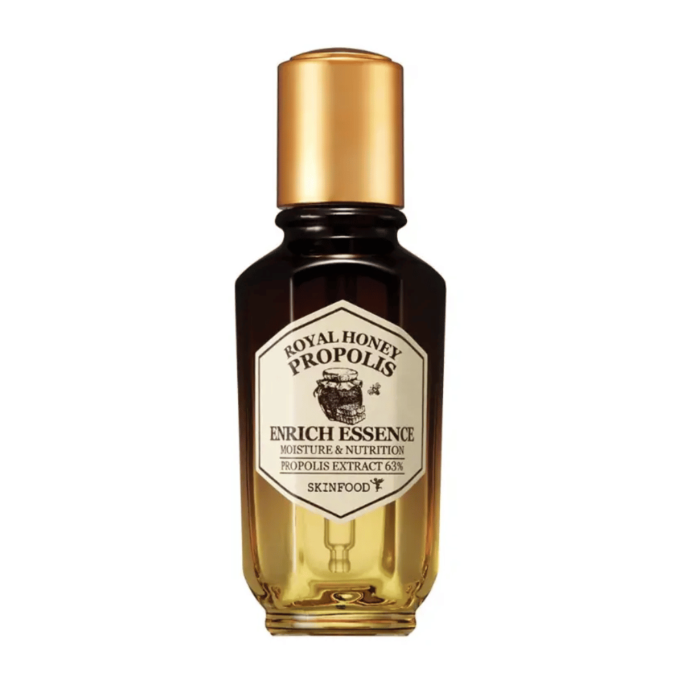 Immagine di una bottiglia di vetro con liquido scuro e tappo dorato. Sull'etichetta della bottiglia c'è scritto "Royal Honey Propolis Enrich Essence" seguito da "Moisture & Nutrition" e "Propolis Extract 63%". Il marchio "Skinfood" è visibile anche in fondo all'etichetta.
