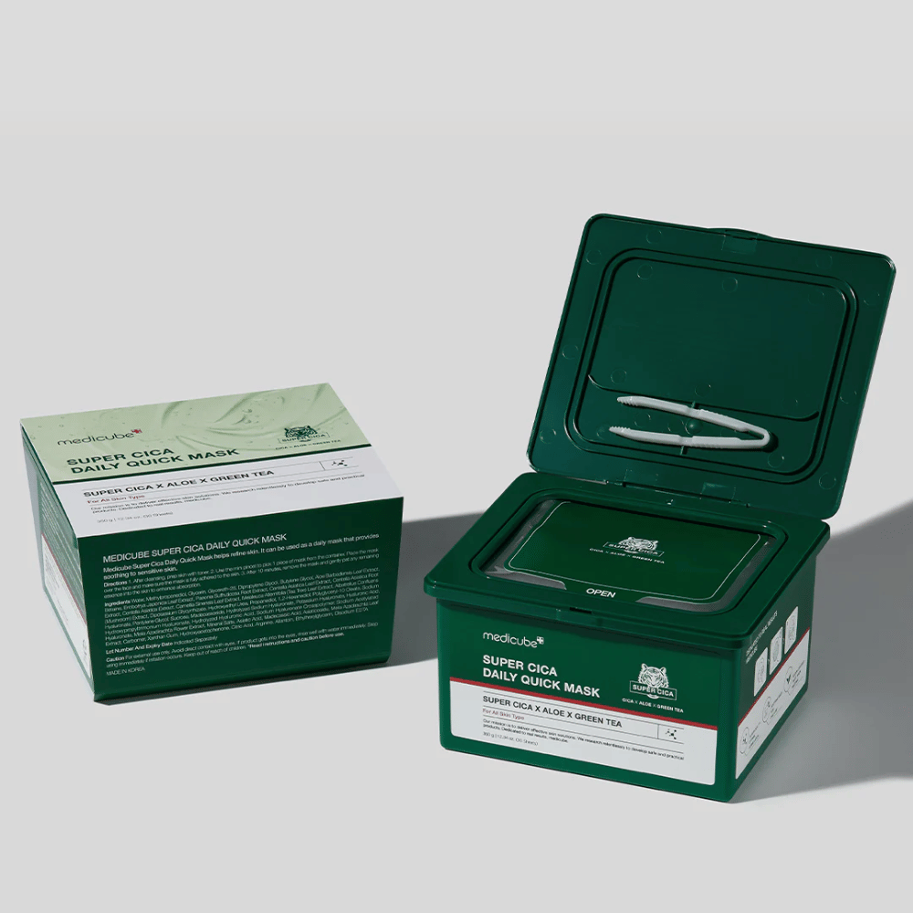 Due confezioni di medicube Super Cica Daily Quick Mask – una scatola chiusa e un contenitore di plastica verde aperto con pinzetta nel coperchio. Le maschere contengono Cica, aloe e tè verde per cura quotidiana ed effetto lenitivo.