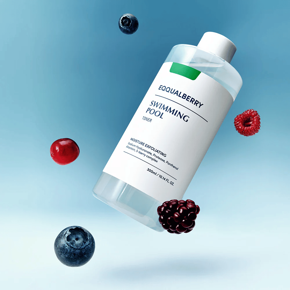 Equalberry Swimming Pool Toner in una bottiglia elegante che fluttua su uno sfondo blu, circondata da bacche fresche come mirtilli, lamponi e more.