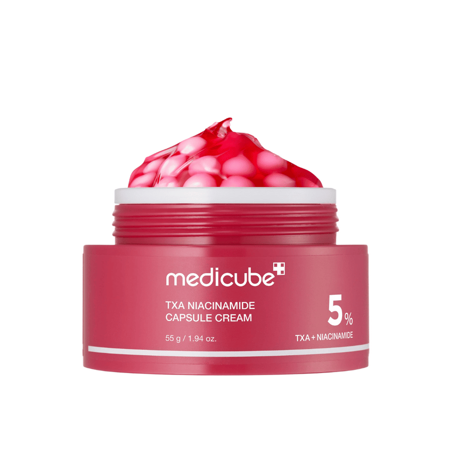 Medicube TXA Niacinamide Capsule Cream in un barattolo con capsule rosa in forma di gelatina, mostrando una chiara marcatura del prodotto con 5% TXA + Niacinamide.