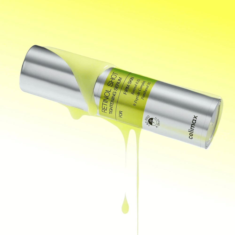 Produktbild av The Vita-A Retinol Shot Tightening Serum från Celimax med gult serum rinnande längs flaskan mot en ljusgul bakgrund.