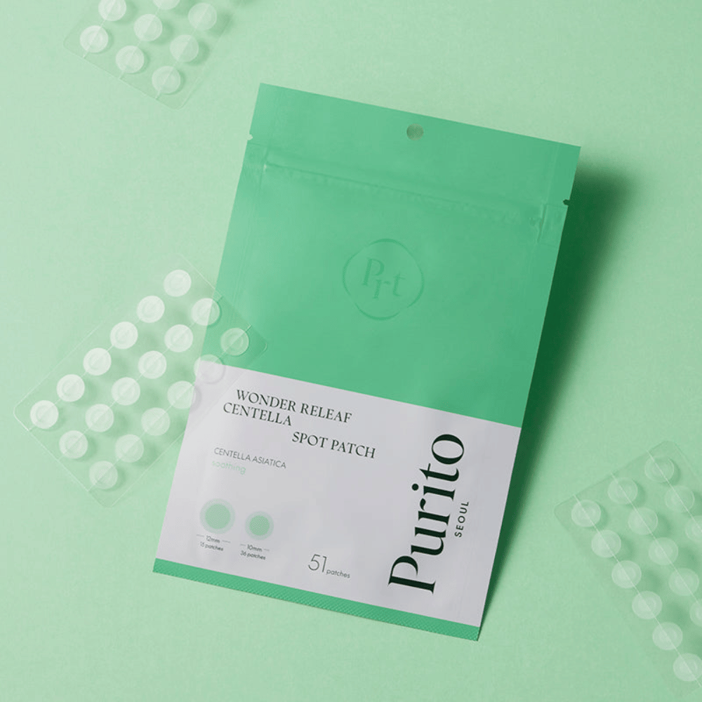 Purito Wonder Releaf Centella Spot Patch su sfondo verde con fogli di cerotti visibili, cerotti per acne lenitivi che riducono il rossore e proteggono dalle impurità.
